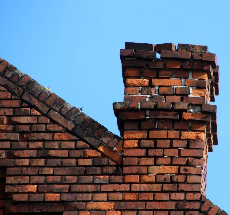 Signs Your Cohasset Home Needs a Chimney Inspection Damaged chimney on an Cohasset home showing cracks and missing mortar